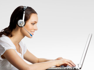 Phone operator in headset with laptop