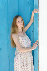 Fashion blonde against the blue door in mykonos island