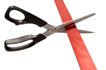 Scissors cutting red tape or ribbon isolated on white background photo