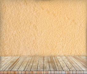 Backdrop sandstone wall and wood slabs arranged in perspective.