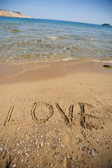 Word love written in sand