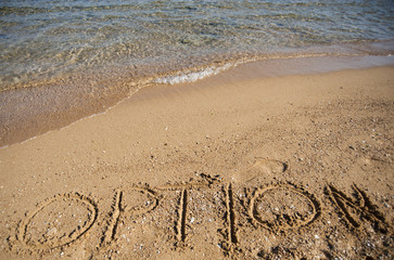 Word option written in sand