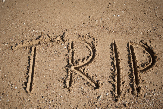 Word trip written in sand
