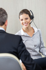 Young Female Customer Service Executive Looking At Manager