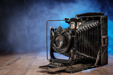 Retro photo Camera on wooden table.