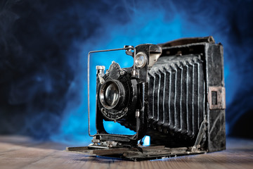 Retro photo Camera on wooden table.
