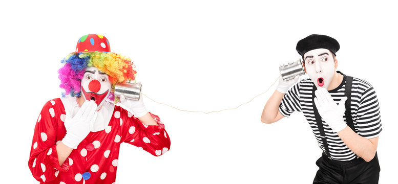Clown and a mime talking through a tin can phone
