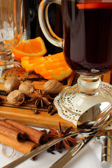 A glass of hot mulled wine and spices.