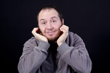 Portrait of man with hands under the chin looking into the camer