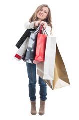 Cute shopping girl showing the shopping bags