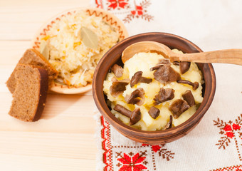 potatoes with mushrooms and sauerkraut on a wooden table, Lenten