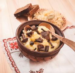potatoes with mushrooms and sauerkraut on a wooden table, Lenten