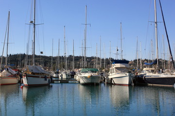 Fototapeta na wymiar Yachts and sail boats reflected in a Marina 