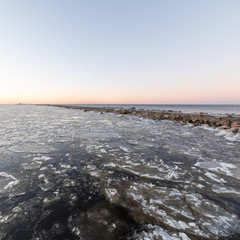 sunset over frozen sea