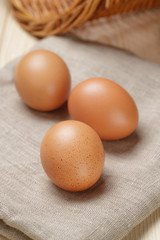 whole raw brown eggs closeup on wood table