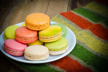 colorful macarons on a wooden floor