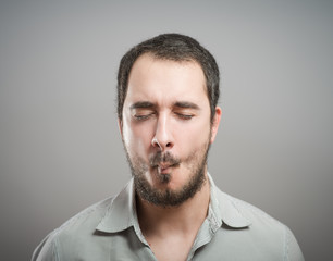 Fototapeta premium young man holding his finger to his templethi