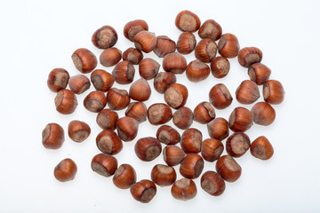 Pile of hazelnuts isolated on white background
