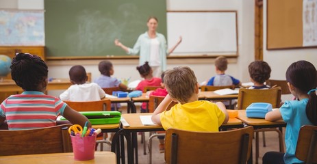 Pupils listening to their teacher at chalkboard
