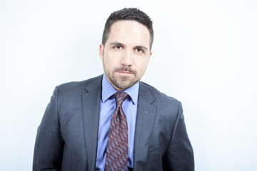 A beautiful business man standing against grey background