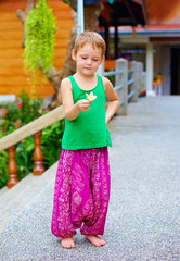 cute kid in asian style clothes holding flower