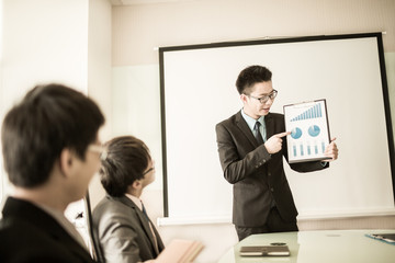 businessman giving a presentation to his colleagues