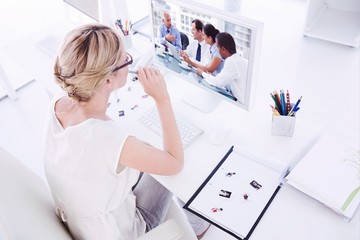 Composite image of female photo editor working on computer