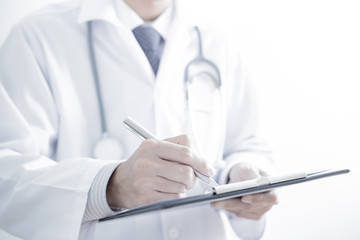 Close-up of male hands filling in medical form