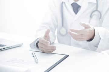 Close-up of male hands filling in medical form