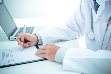 Close-up of male hands filling in medical form