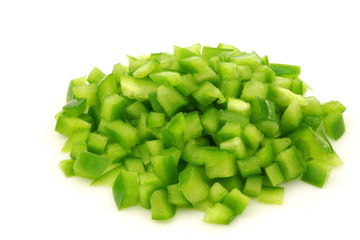 cut pieces of green paprika (capsicum) on a white background