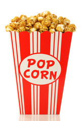 caramel popcorn in a paper popcorn cup on a white background