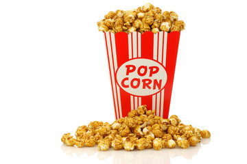 caramel popcorn in a paper popcorn cup on a white background