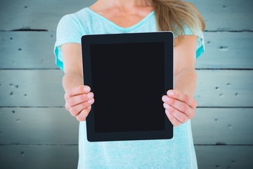 Composite image of mid section of woman showing a tablet pc