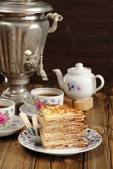 Russian bliny with vintage samovar and teaware