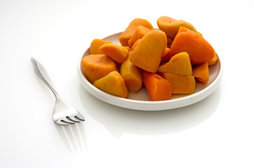 Canned yams on a white reflective table