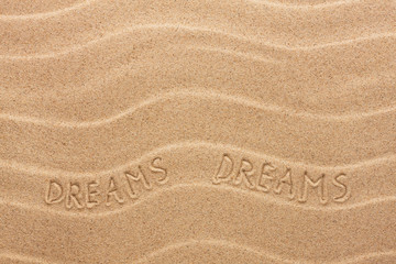 Dream inscription on the wavy sand