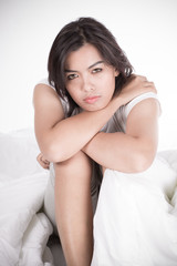 Portrait of a beautiful young woman in bed