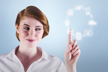 Composite image of businesswoman smiling and pointing