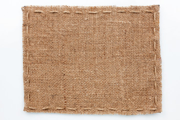Frame of burlap  lies on a white  background
