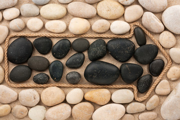 Pointer made of rope with white and black stones