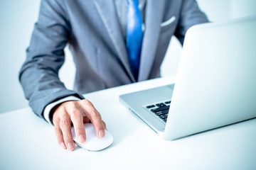 Closeup of businessman hands typing on laptop computer