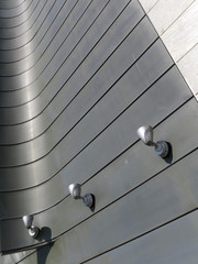Halogen metal reflectors on modern building grey wall