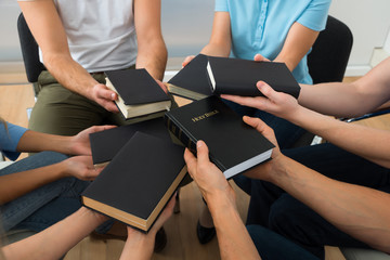 Group Of People Holding Holy Bible