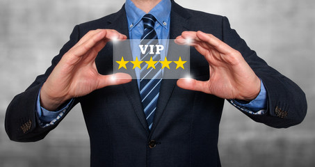 Businessman holds vip five stars in his hands. Grey