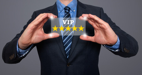 Businessman holds vip five stars in his hands. grey