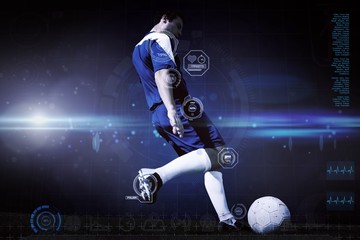 Composite image of football player kicking ball