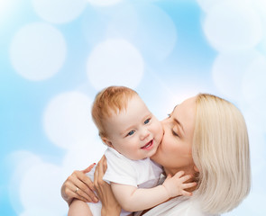 happy mother kissing smiling baby