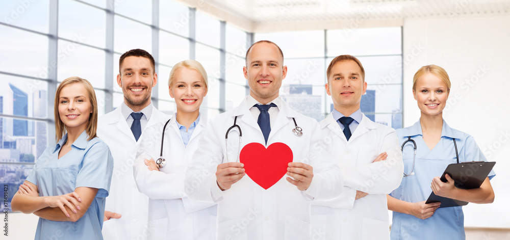 Fototapete happy young doctors cardiologists with red heart