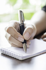 Fototapeta premium closeup of woman hands taking note